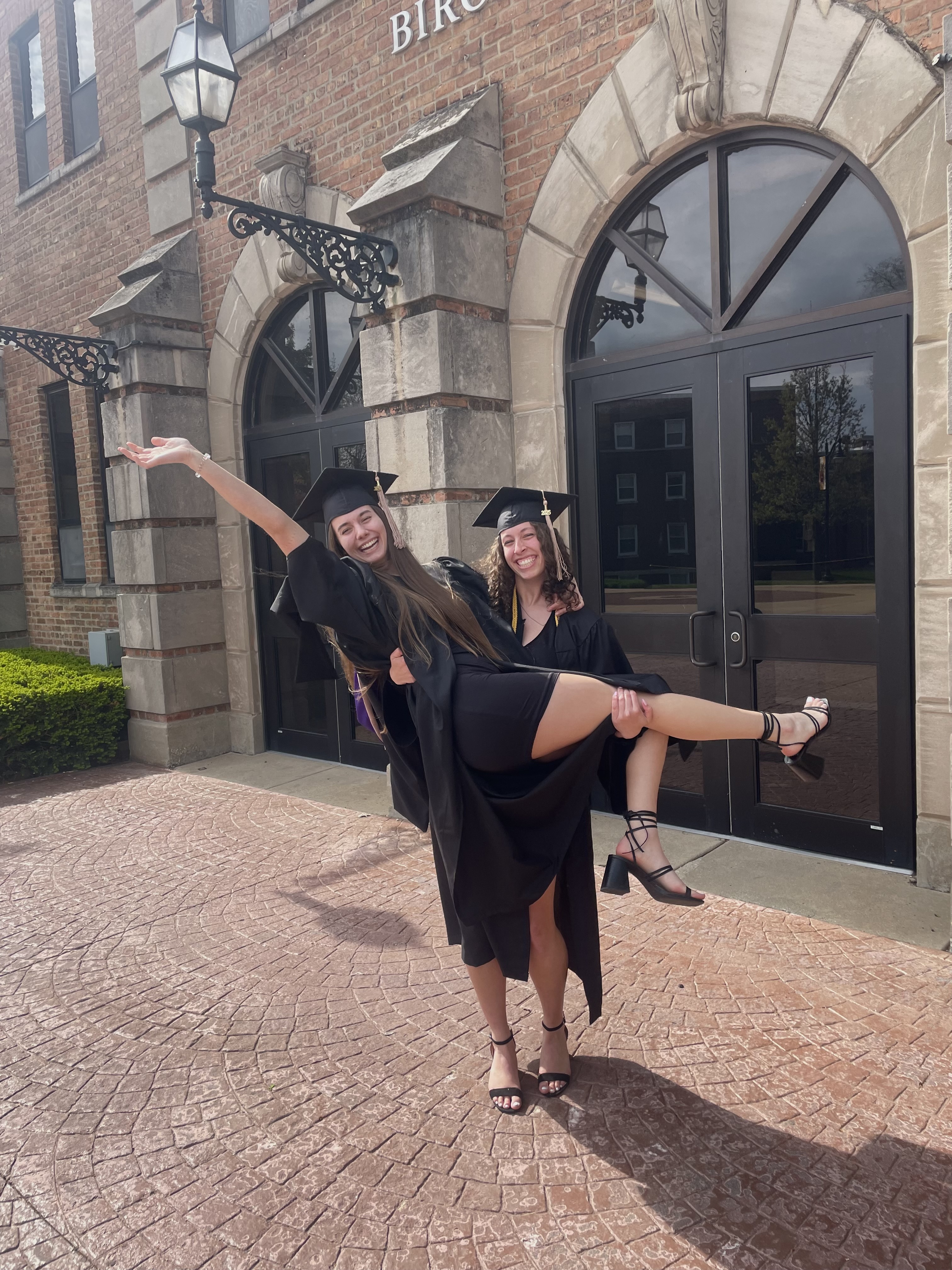 Mia with her sister in front of the Birchard Gym at Olivet.