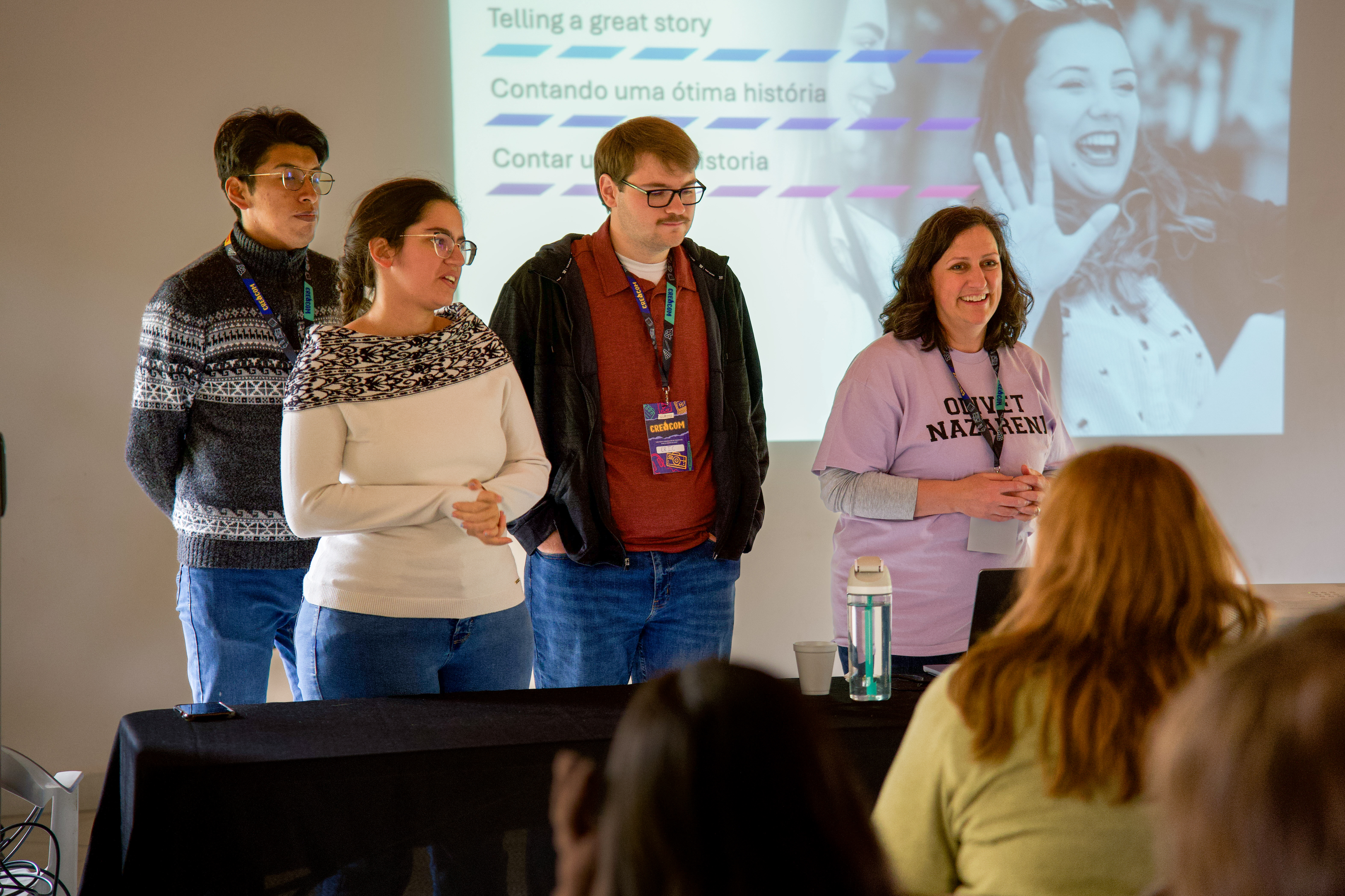 A group of people presenting in front of a room.