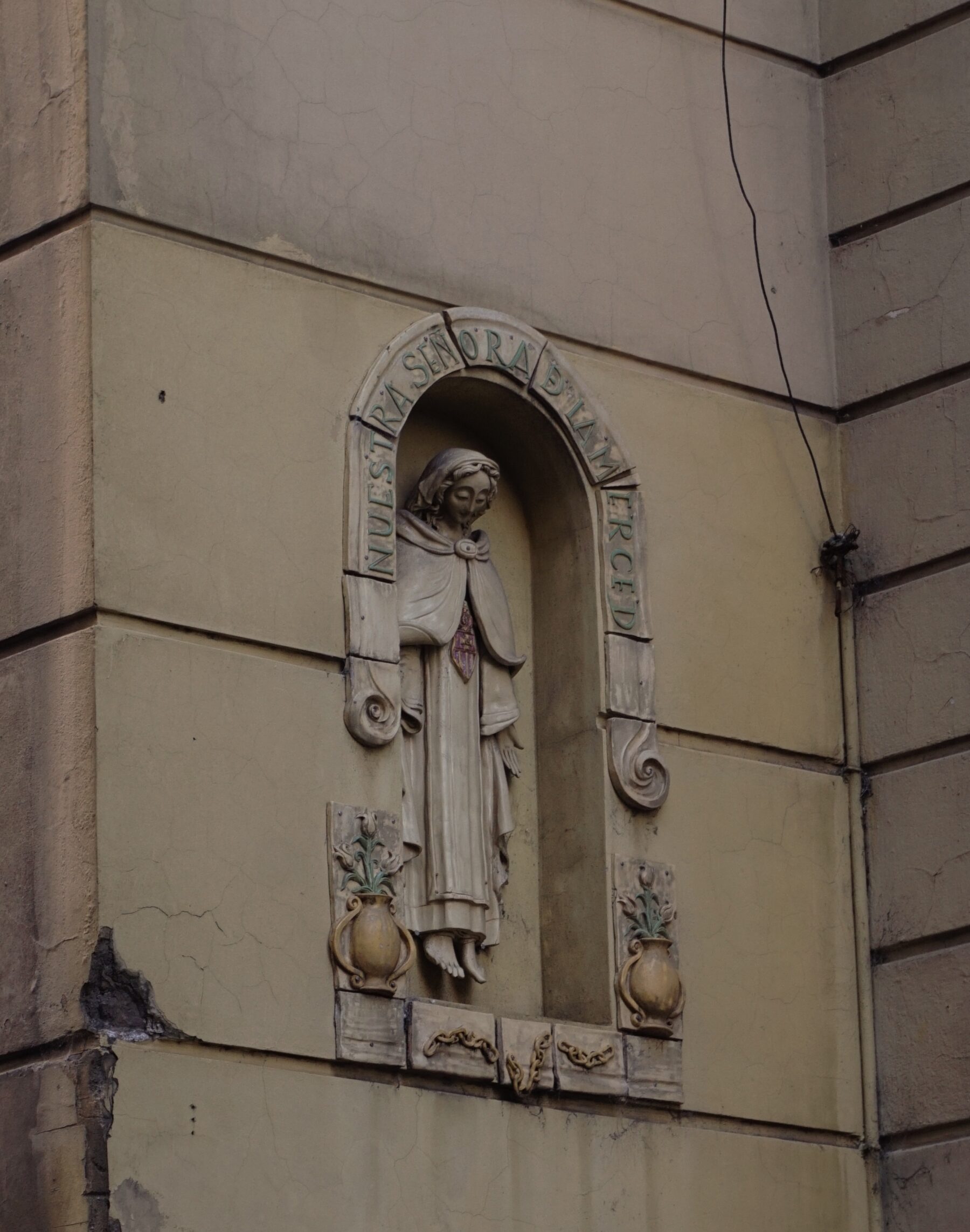 A picture of a statue carved into the side of a building.