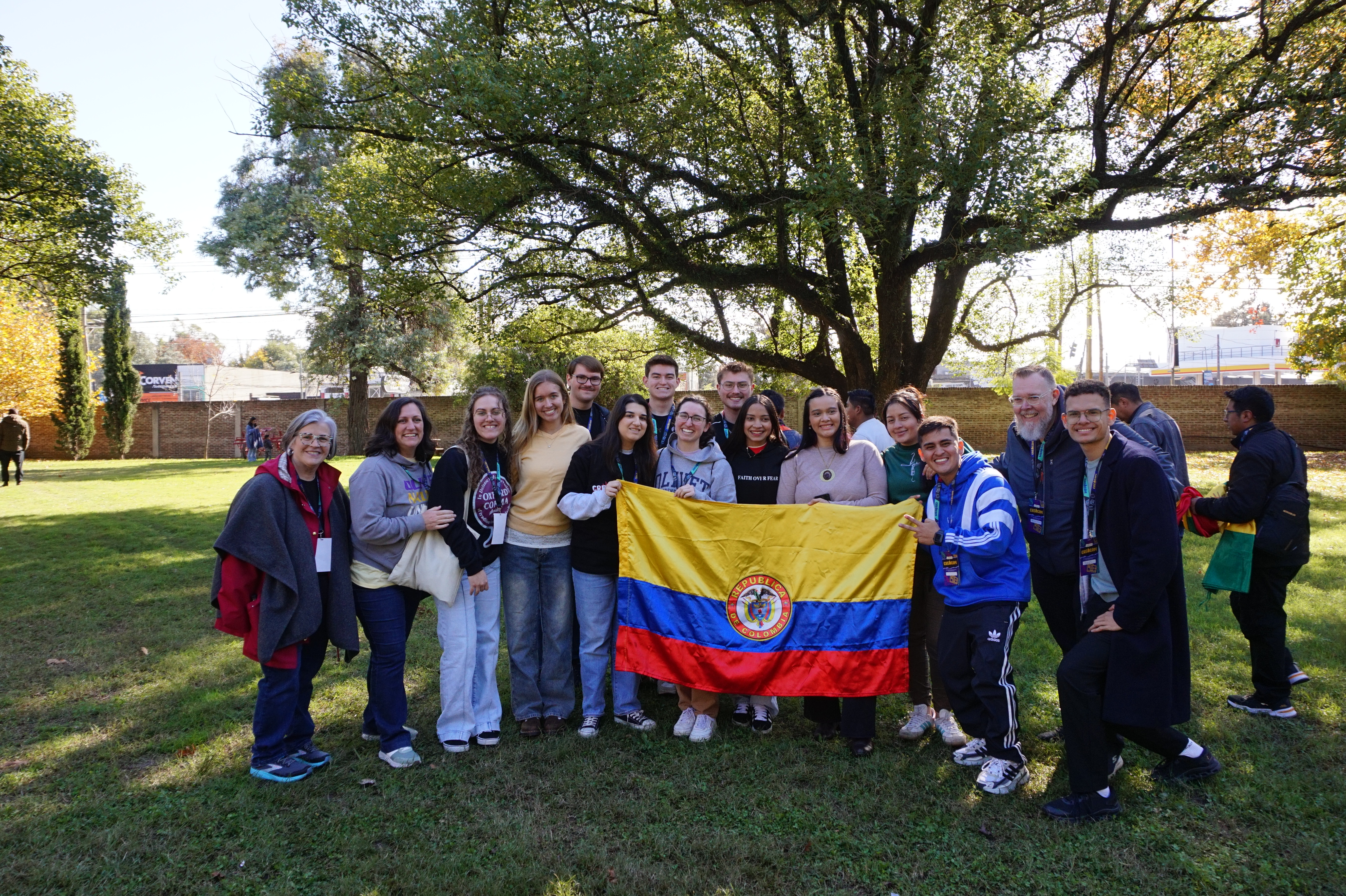 A picture of the group posing for a picture with a flag.