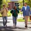 A picture of Jason walking with two students on Olivet's campus.