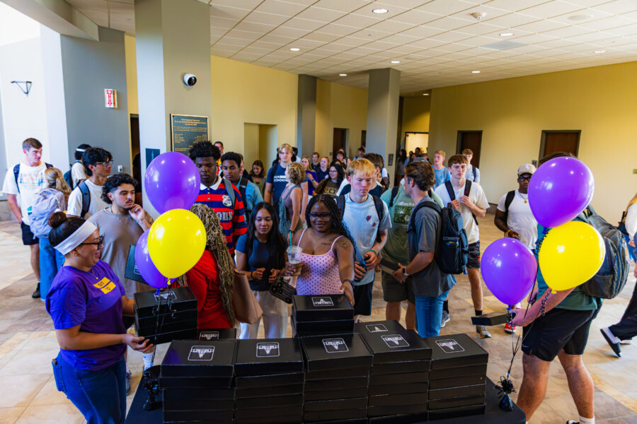 A picture of students in the lobby receiving their Bibles.