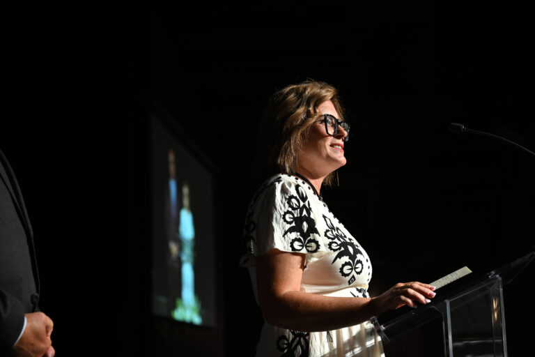 A picture of Tammy speaking to the crowd.