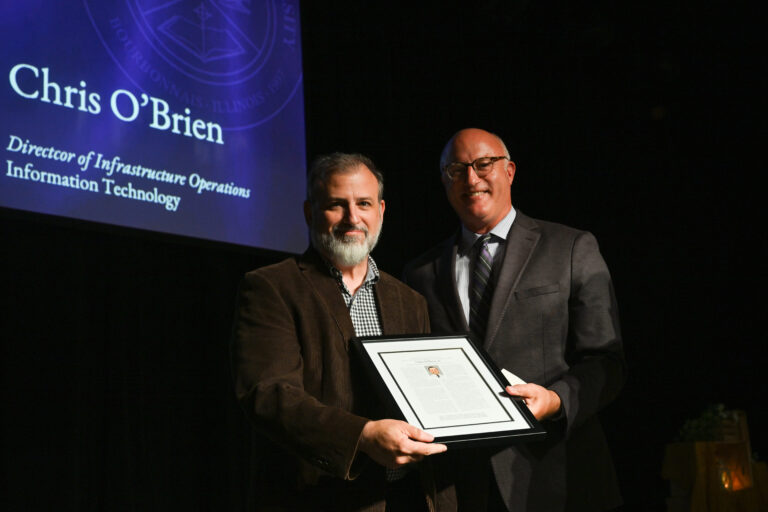 A picture of Chris receiving his award from Dr. Chenoweth