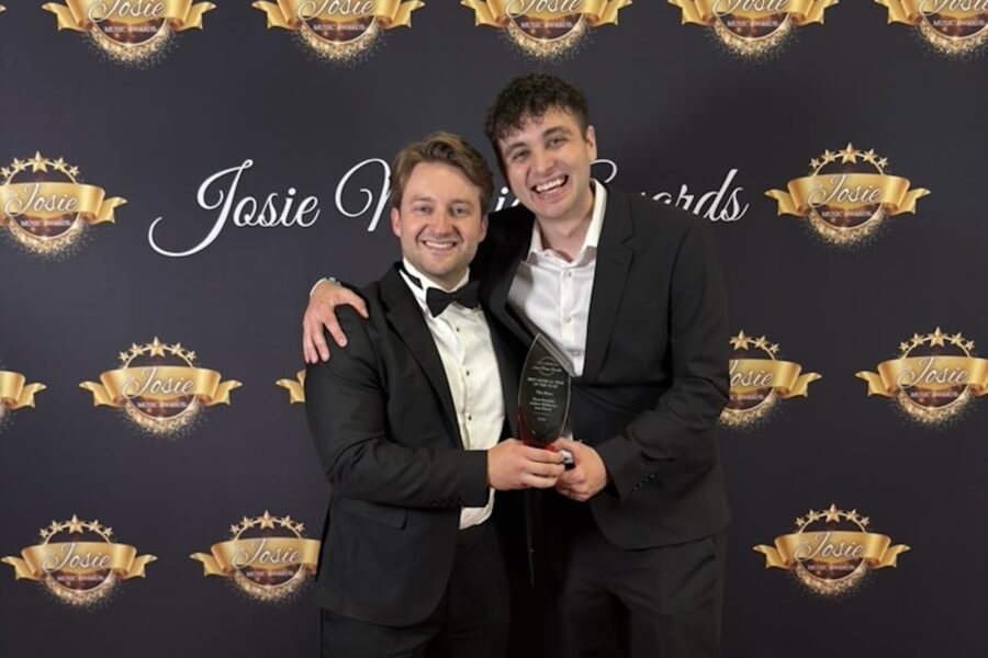 two men holding an award